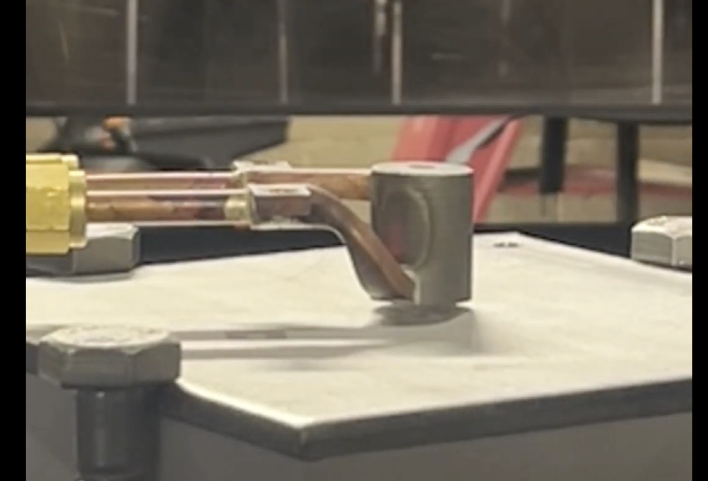 Small resin 3D print test piece on the printer bed