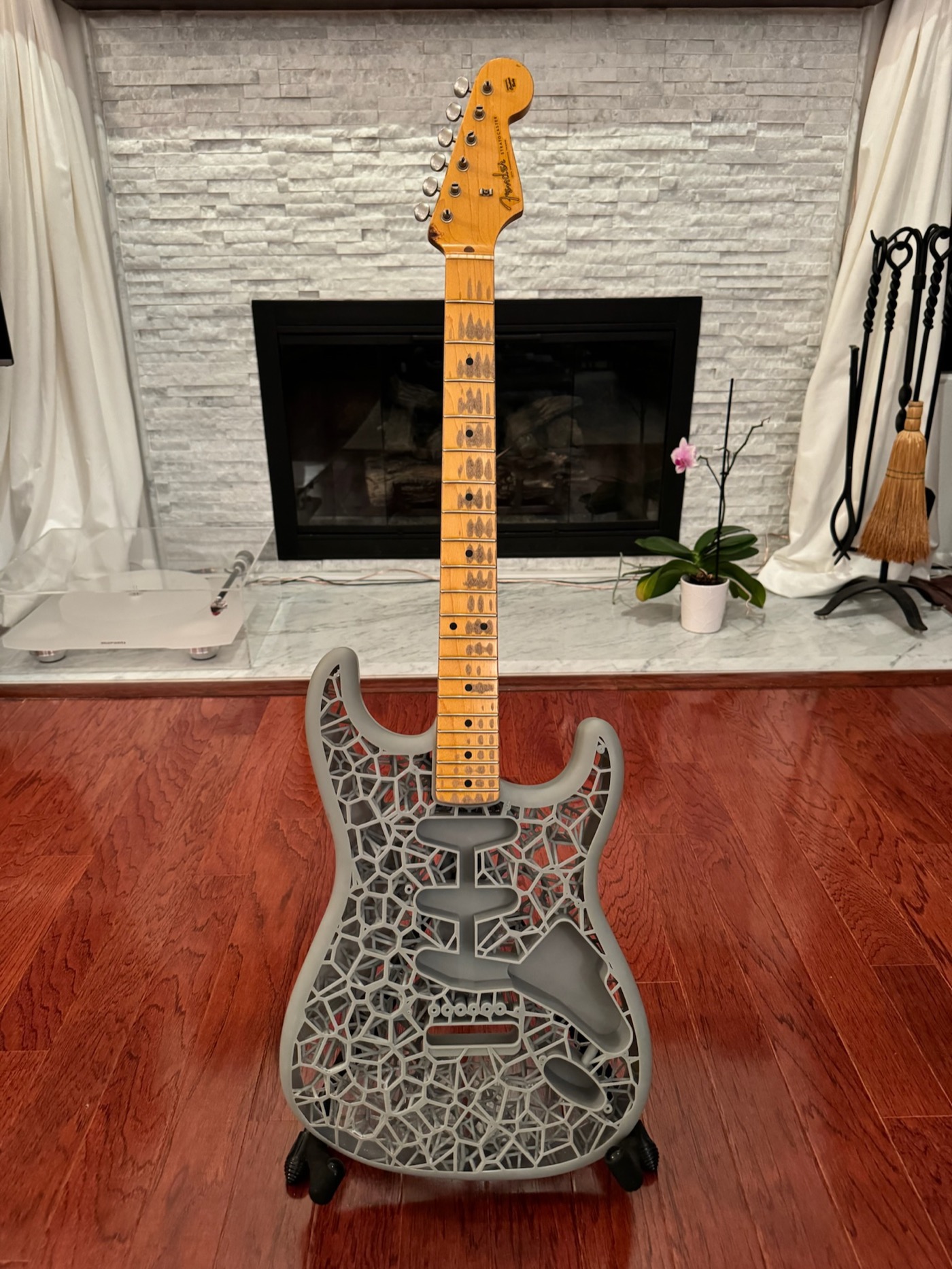 Full resin Voronoi Stratocaster prototype standing upright by a fireplace with Fender Clapton neck