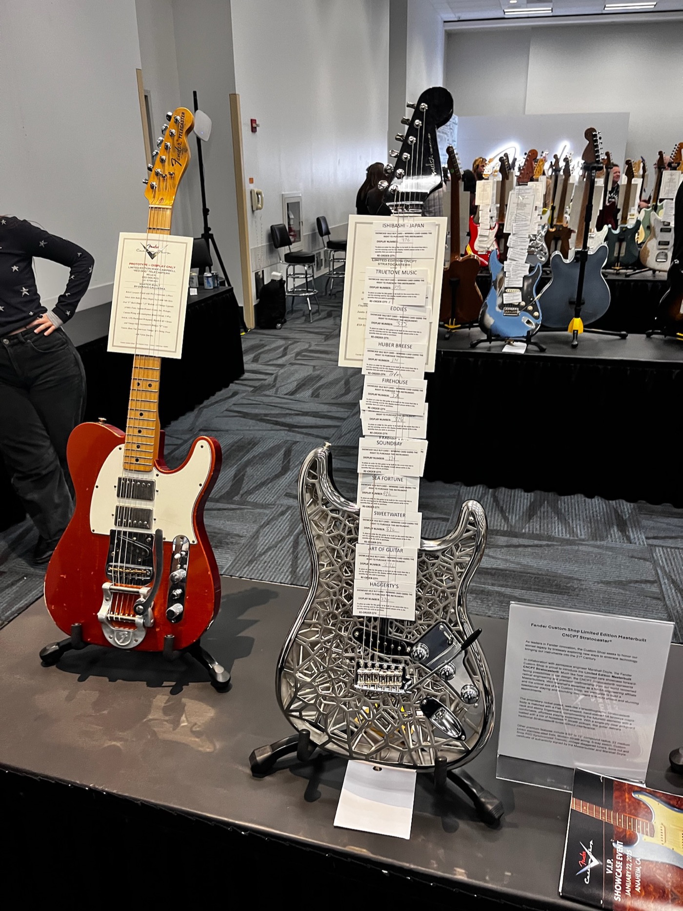NASAcaster on display stand at NAMM 2025 with Fender Custom Shop spec card