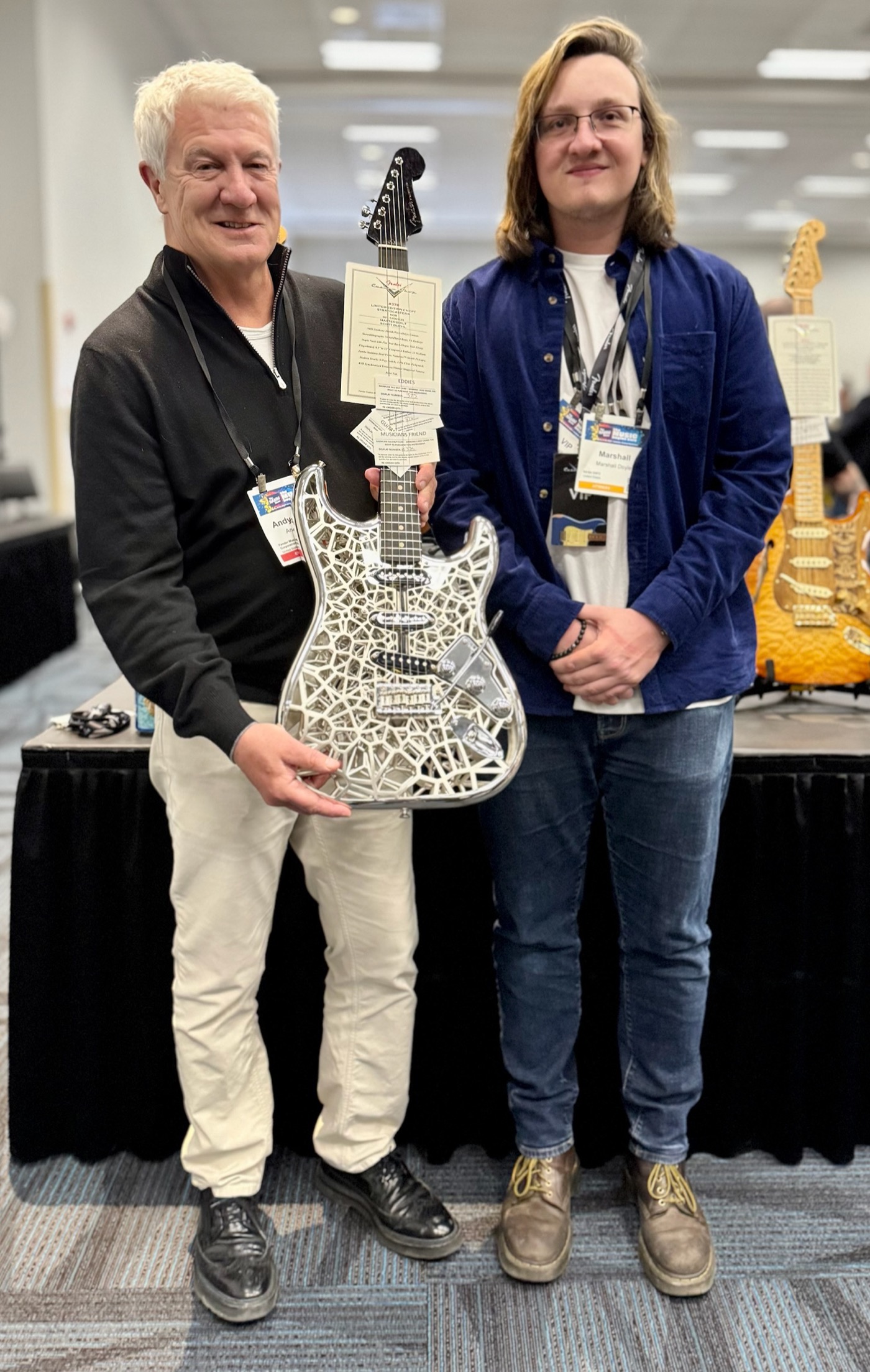 Showing the NASAcaster to an attendee at NAMM 2025